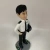 這是一份意義非凡的【晉升】賀禮，為一位年輕的【警務人員】訂製的專屬【人像公仔】。 從公仔的制服細節——尤其是肩上的一條銀色橫柴——我們可以推斷，這位【警務人員】榮升的職位是「見習督察」，這是其警隊生涯一個光輝的起點。公仔自信的笑容與輕鬆的站姿，正是這份喜悅的最佳寫照。 作品設計簡潔而專注，將所有焦點都集中在主角身上，底座的小花點綴，則象徵著他未來職業道路的無限生機。 這份禮物不僅僅是一件擺設，它更是一份認可、一個見證，紀念著他通過努力，成功邁入警官行列的決定性時刻。